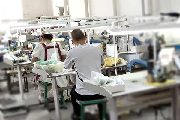 Workers at eyewear factory production line