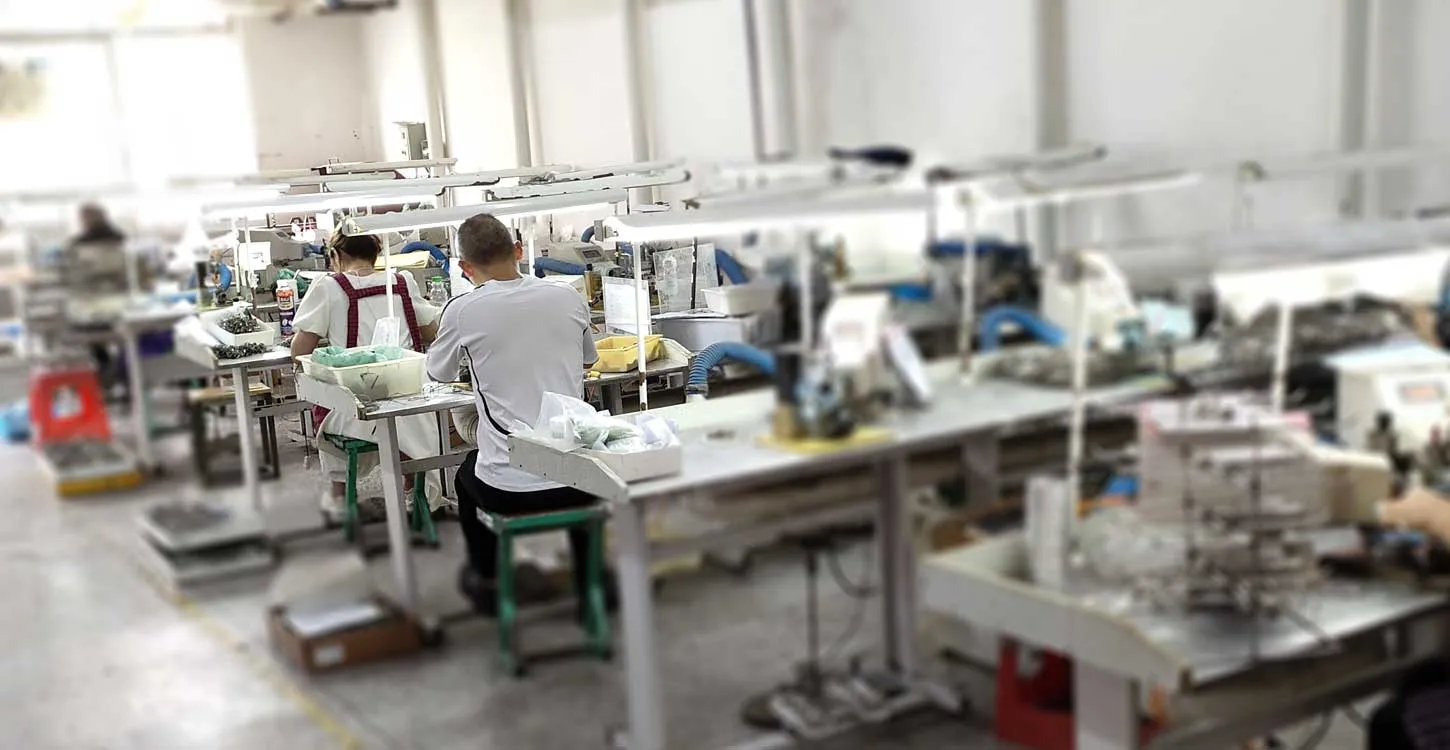 Workers at eyewear factory production line